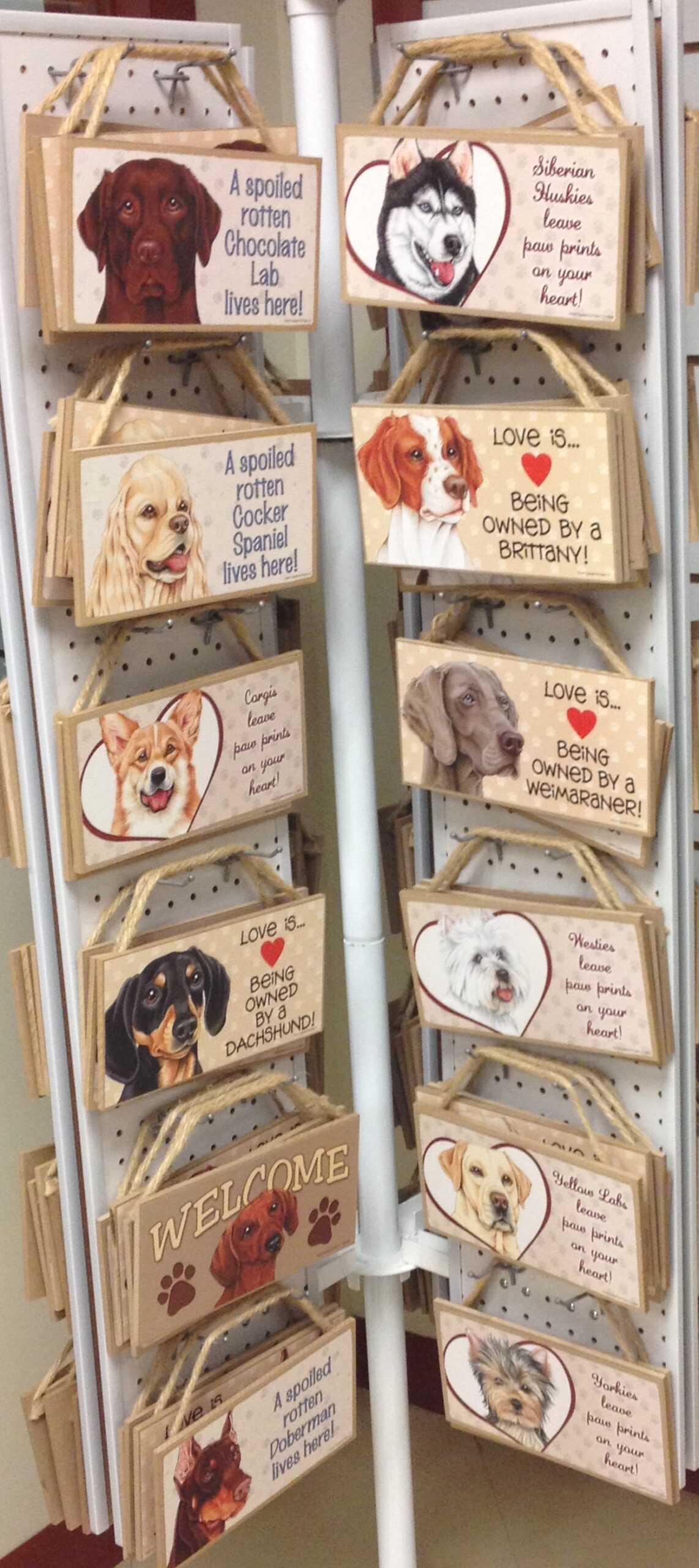 Colorful wooden signs featuring various dog breeds with humorous phrases about pet ownership. Perfect for dog lovers, enhancing home decor.